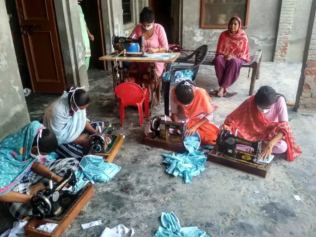 Women working at sewing machines in a livelihood programme