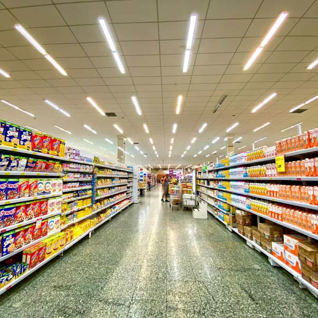 Brightly stocked shelves along a retail store aisle