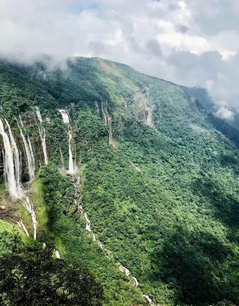 Waterfalls falling from forested cliffs in the hills of the North East