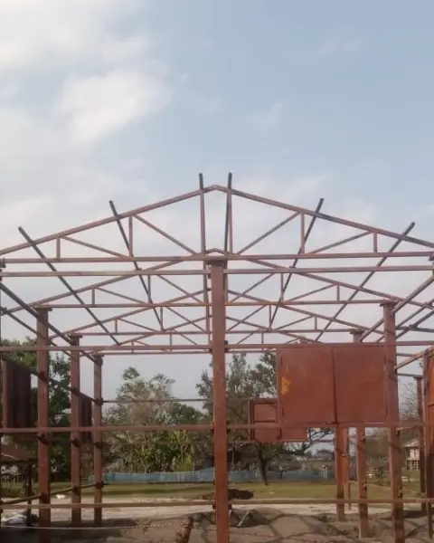 A steel roof truss frame against the sky